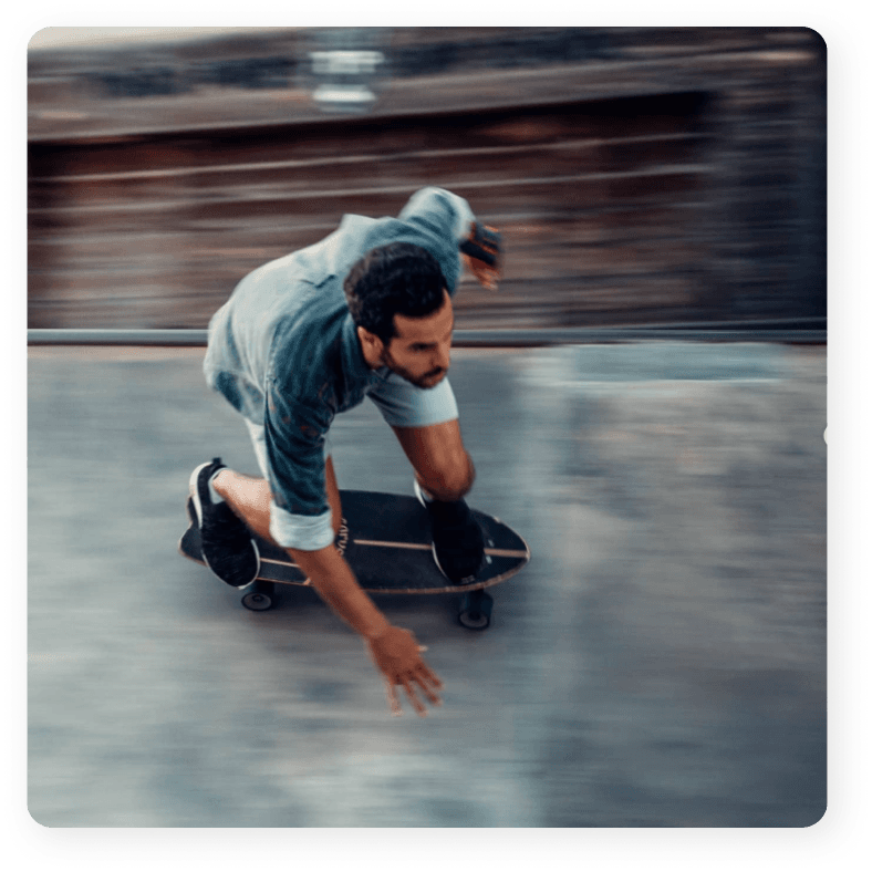 Domingo Barros, Co-Founder, shredding on a surf skate in a cement bowl.